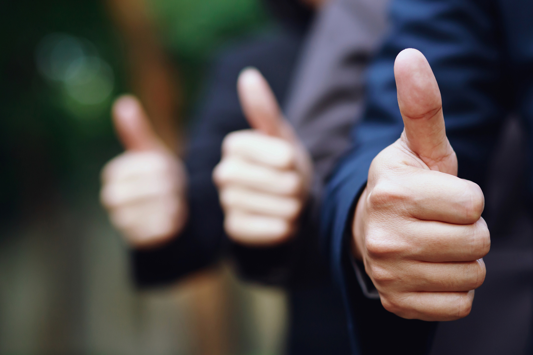 Selective Focus of Businessmen Giving a Thumbs Up Outdoors